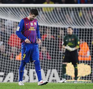 Gerard Pique of Barcelona leaves the pitch after being shown a red card on during the La Liga match against Sporting Gijon