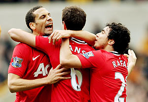 Rio Ferdinand (left) and Rafael Da Silva (right) of Manchester United celebrate with Jonny Evans