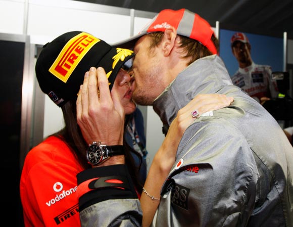 McLaren driver Jenson Button kisses his girlfriend Jessica Michibata after winning the Australian Grand Prix