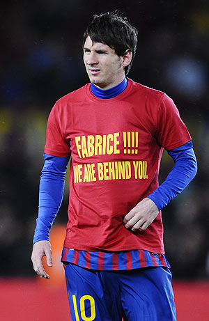 Lionel Messi wears a shirt in support of Fabrice Muamba of Bolton Wanderers prior to the La Liga match between FC Barcelona and Granada on Tuesday