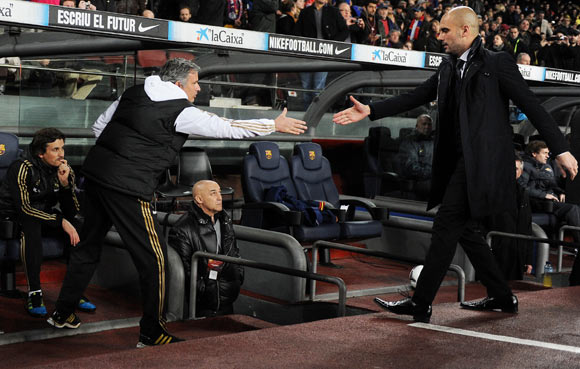 Head coach Josep Guardiola (R) of FC Barcelona greets head coach Jose Mourinho of Real Madrid during the Copa del Rey quarter final second leg match between Barcelona and Real Madrid at Camp Nou