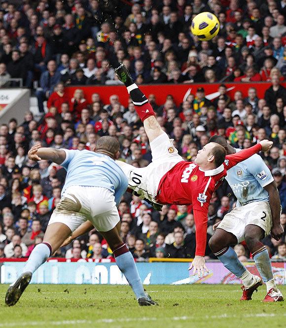 Manchester United's Wayne Rooney scores against Manchester City from an overhead kick during their EPL match at Old Trafford on February 12, 2011