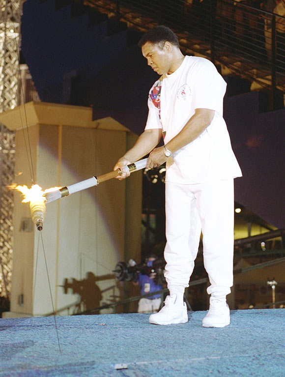 Muhammad Ali holds the torch before lighting the Olympic Flame during the Opening Ceremony of the 1996 Centennial Olympic Games in Atlanta, Georgia