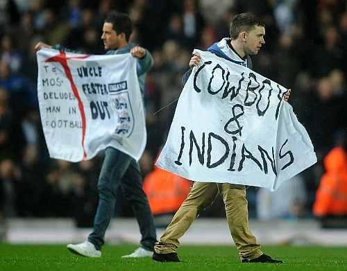 Blackburn fans with banners invade the pitch at the end of the Barclays Premier League