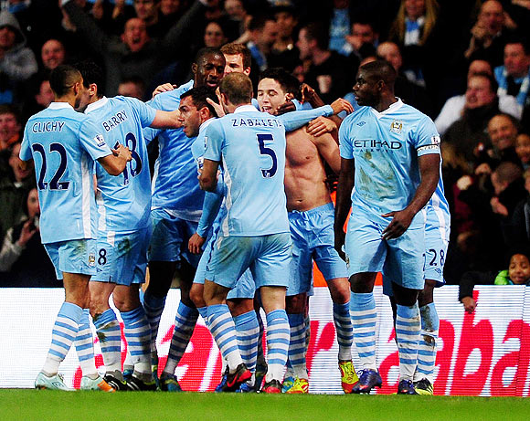 Samir Nasri (unshirted) of Manchester City is congratulated by teammates