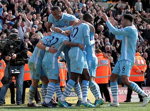 Manchester City players celebrate after winning the game
