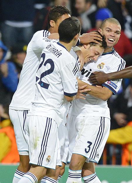 Real Madrid's Mesut Ozil (2nd from right) celebrates with teammates after scoring a last minute equaliser against Borussia Dortmund