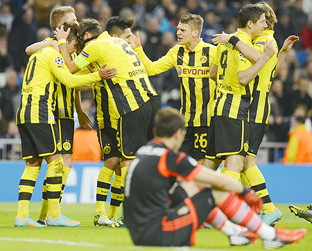 Real Madrid's goalkeeper Iker Casillas watches as Borussia Dortmund's players celebrate their second goal