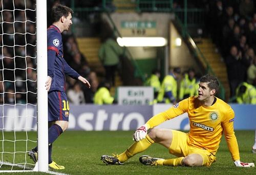 Barcelona's Lionel Messi looks down at Celtic goalkeeper Fraser Forster