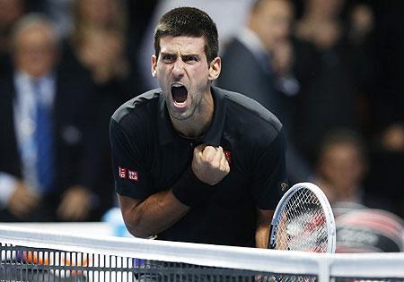 Serbia's Novak Djokovic celebrates beating Switzerland's Roger Federer in their final at the ATP World Tour Finals on Monday