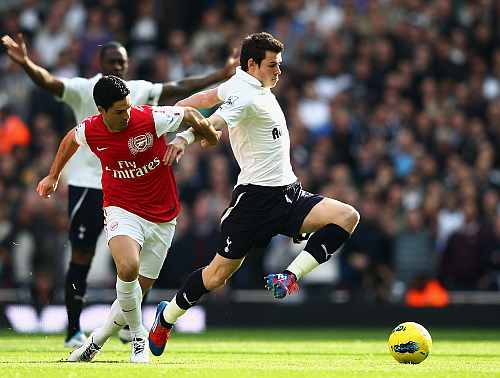 Gareth Bale of Tottenham Hotspur is challenged by Mikel Arteta of Arsenal
