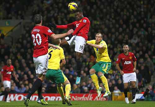 Danny Welbeck of Manchester United heads the ball in front of the Norwich City goal during their English Premier League match