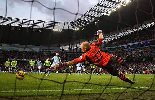 Sergio Aguero of Manchester City scores his team's second goal, from the penalty spot, to make the score 2-0 during the Barclays Premier League match
