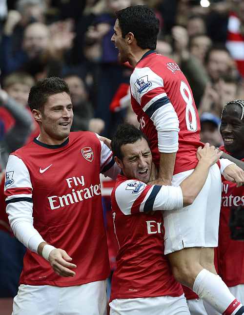 Arsenal's Santi Cazorla (C) celebrates with team mates after scoring against Tottenham Hotspur during their English Premier League match