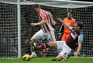 West Ham United's Kevin Nolan (right) challenges Stoke City's Robert Huth as they vie for the ball during their English Premier League match at Upton Park on Monday