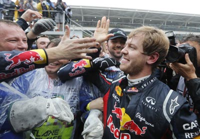 Red Bull's Sebastian Vettel celebrates winning the world championship with his team after finishing sixth in the Brazilian F1 GP
