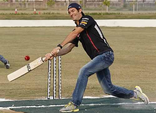 Red Bull Formula One driver Mark Webber plays cricket with India's Gautam Gambhir