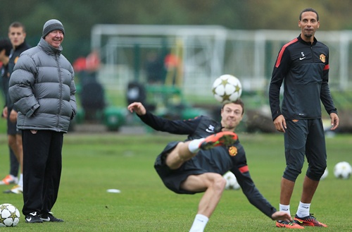 Sir Alex Ferguson jokes with Rio Ferdinand during the Manchester United Training Session