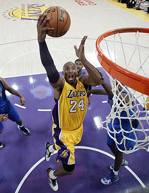 Los Angeles Lakers shooting guard Kobe Bryant (24) drives to the hoop to score against the Dallas Mavericks during their NBA basketball game on Tuesday
