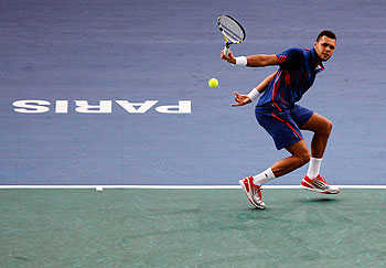 Jo-Wilfried Tsonga plays a return against Julien Benneteau during their second round match on Tuesday