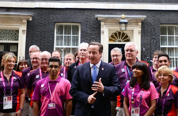 British Prime Minister David Cameron (centre) greets Olympic Gamesmakers at Downing Street