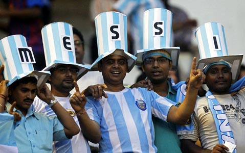 Indian fans cheer for Lionel Messi during the friendly soccer match between Argentina and Venezuela in Kolkata in September last year