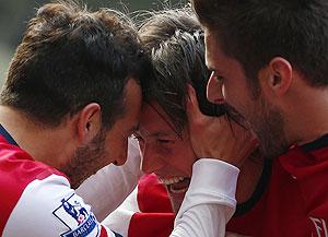 Arsenal's Tomas Rosicky (centre) celebrates his second goal with Santi Cazorla (left) during their English Premier League match against West Bromwich on Saturday