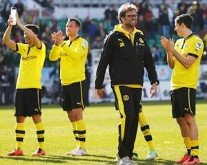 Juergen Klopp, coach of Borussia Dortmund, celebrates with his players