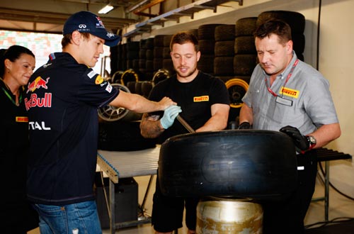 Sebastian Vettel of Germany and Red Bull Racing takes part in a Pirelli tyre change challenge