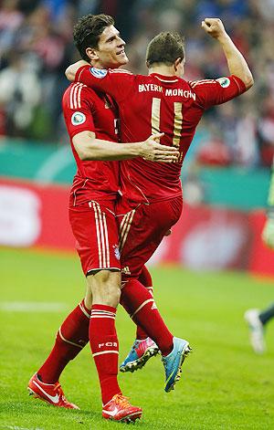 Bayern Munich's Xherdan Shaqiri (right) celebrates with Mario Gomez after a goal against Wolfsburg during their German soccer cup (DFB Pokal) semi-final match in Munich on Tuesday