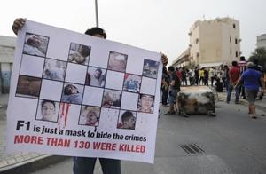 A protester holds an anti-F1 banner