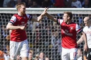 Arsenal's Per Mertesacker (left) celebrates scoring against Fulham with teammate Nacho Monreal