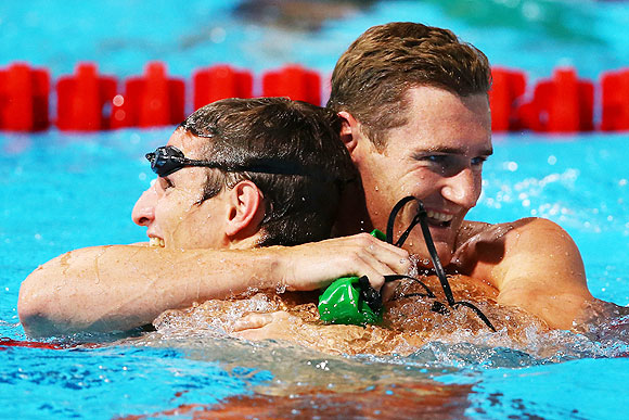 Cameron Van Der Burgh of South Africa (right) celebrates with compatriot Giulio Zorzi after winning the Swimming Men's 50m Breaststroke final on Wednesday
