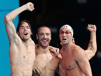 Camille Lacourt, Fabien Gilot and Jeremy Stravius of France celebrate after the USA are disqualified and they were announced winners of the swimming men's medley 4x100m relay final on at the 15th FINA World Championships at Palau Sant Jordi in Barcelona, Spain, on Sunday