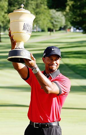 Tiger Woods holds up the Gary Player Cup trophy after the Final Round of the World Golf Championships-Bridgestone Invitational at Firestone Country Club South Course in Akron, Ohio. on Sunday 