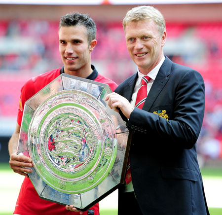 Robin van Persie of Manchester United and manager David Moyes pose with the trophy after victory in the FA Community Shield