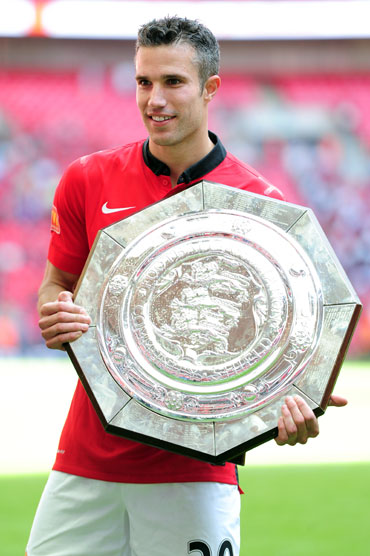 Robin van Persie of Manchester United poses with the trophy after victory in the FA Community Shield