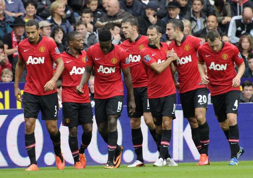 Manchester United players celebrate after scoring 