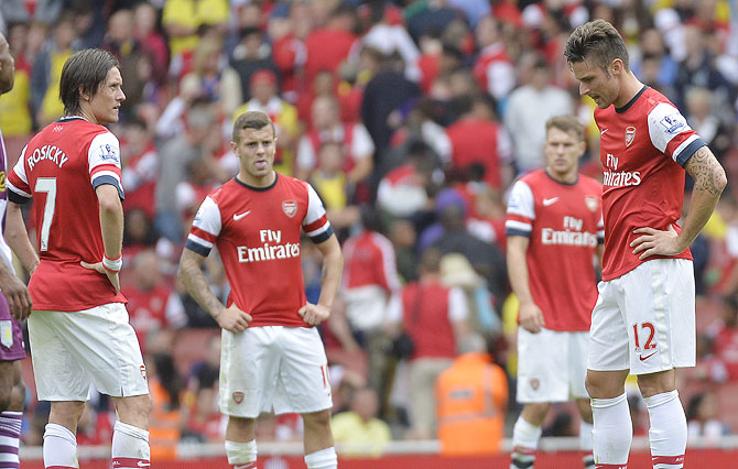 Arsenal players (left to right) Tomas Rosicky, Jack Wilshere, Aaron Ramsey and Olivier Giroud react after conceding a third goal to Aston Villa during their Premier League match on Saturday