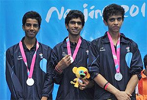 India's silver-medal winning squash trio of Madhav Yogesh Dhingra, Kush Kumar and Vijay Meena on the podium during the medal ceremony