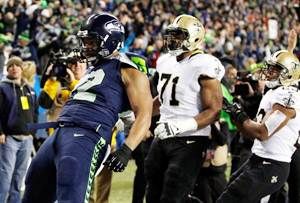 Defensive end Michael Bennett #72 of the Seattle Seahawks celebrates a first quarter touchdown
