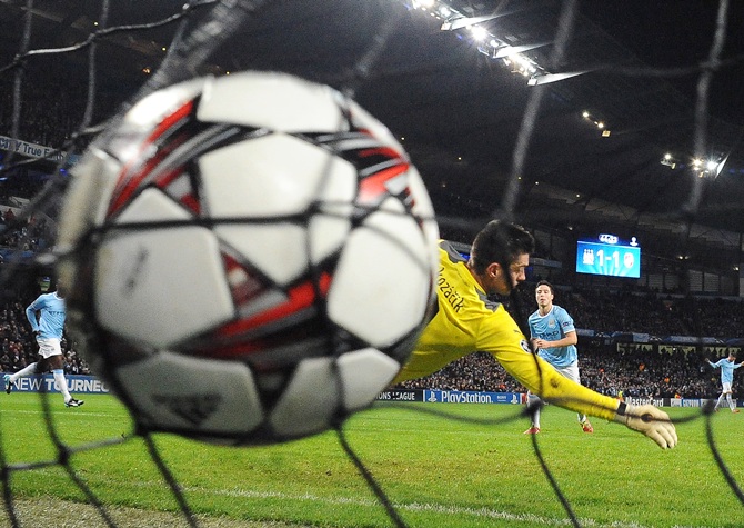 Manchester City's Samir Nasri (right) shoots to score