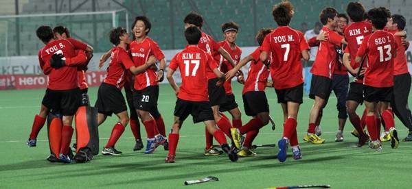 The Koreans celebrate after forcing a draw and qualifying for the quarter-finals