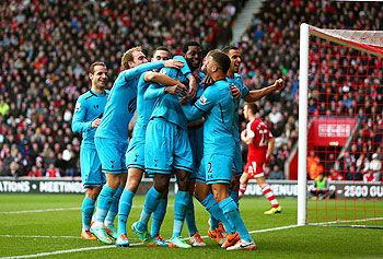 Emmanuel Adebayor (centre) of Spurs celebrates with teammates after scoring his team's third goal against Southampton at St Mary's Stadium in Southampton on Sunday