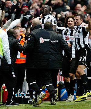 Moussa Sissoko (centre) of Newcastle celebrates his winning goal with teammates and staff during their match against Chelsea on Saturday