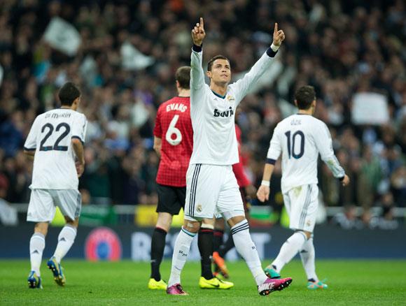 Cristiano Ronaldo of Real Madrid celebrates scoring his sides equalizing goal against Manchester United at Estadio Santiago Bernabeu