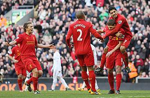 Liverpool's Steven Gerrard celebrates with Luis Suarez, Glen Johnson and Lucas after scoring the first goal from the penalty spot against Swansea on Sunday