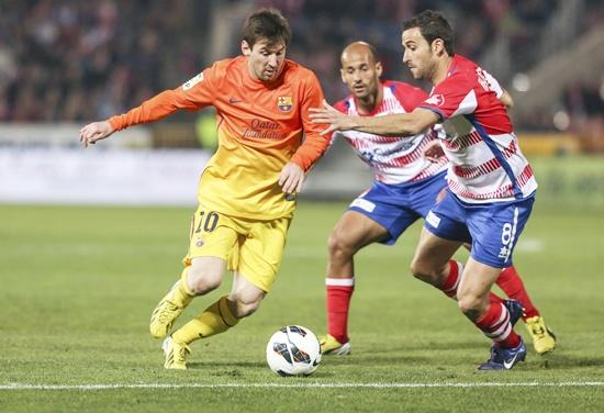 Barcelona's Lionel Messi (left) controls the ball