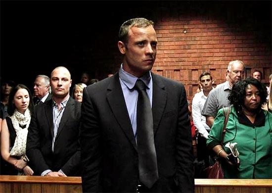 Oscar Pistorius awaits the start of court proceedings in the Pretoria Magistrates court