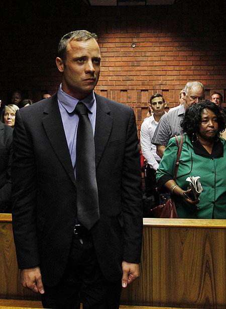 Oscar Pistorius awaits the start of court proceedings in the Pretoria Magistrates court on Tuesday